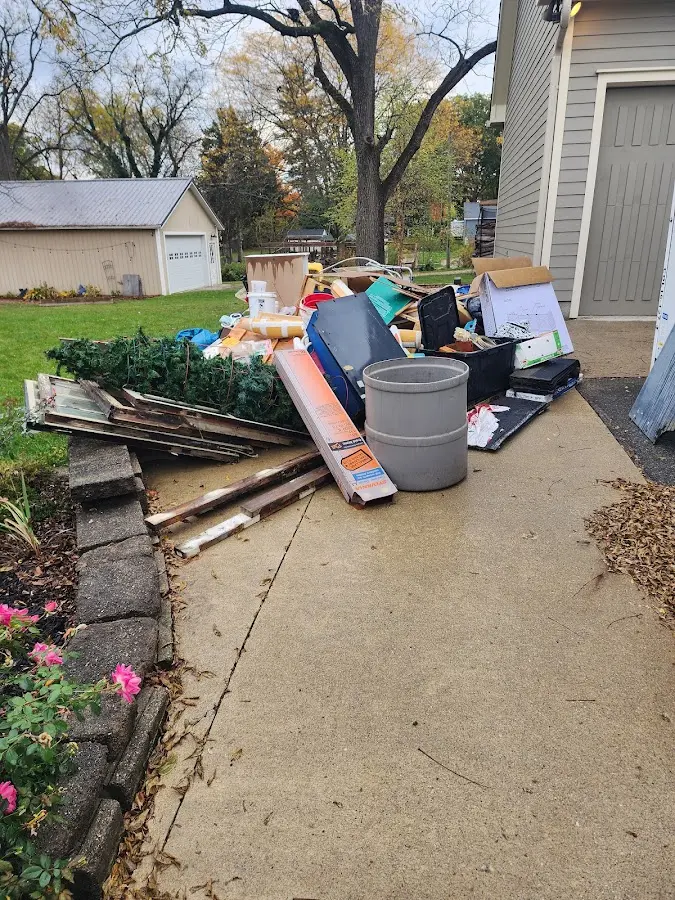 Dumpster being loaded with debris for Estate Cleanout Dumpster Rental in Frenchtown